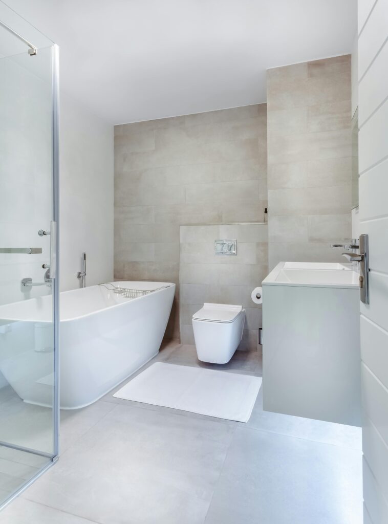 Elegant minimalistic bathroom featuring bathtub and sleek fixtures.