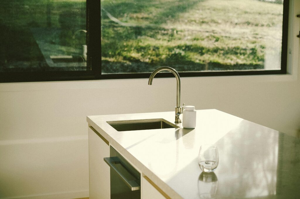 A sleek kitchen showcasing modern design and minimalist aesthetics with natural lighting.